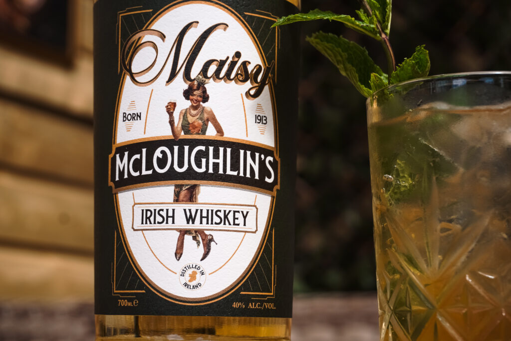 Close-up of the Maisy McLoughlin's label beside a glass
